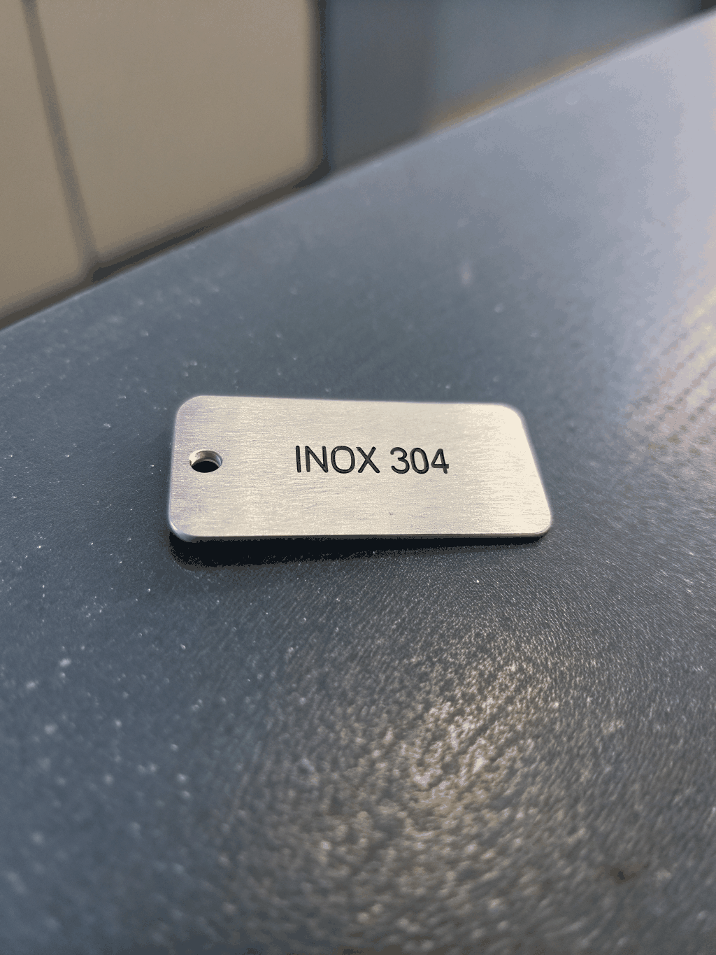 Durable engraved metal asset tag detail