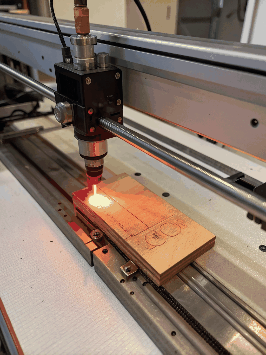 Industrial fiber laser engraving a stainless steel component with precision